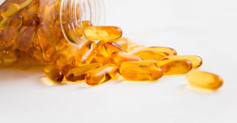 Medicine - Spilled Bottle of Yellow Capsule Pills